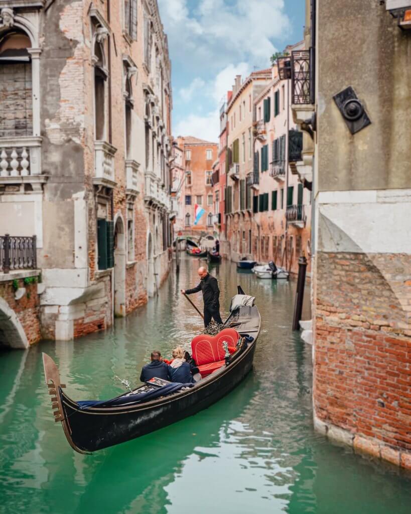 A gondola gliding through the canals of Venice Italy