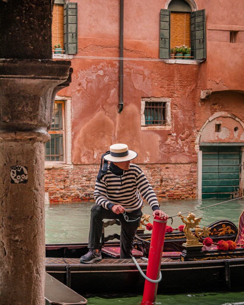 Gondolier on the canals of Venice Italy