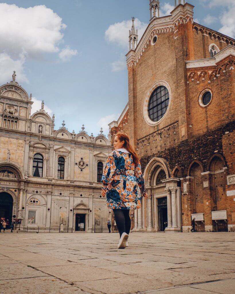 Woman walking in the piazza of Ospedale SS Giovanni e Paolo in Venice Italy