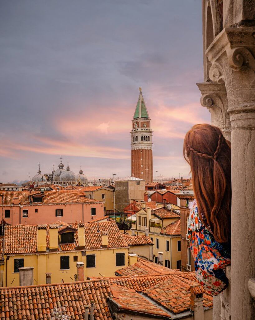 Woman looking at a rooftop view of the best Instagram spots in Venice