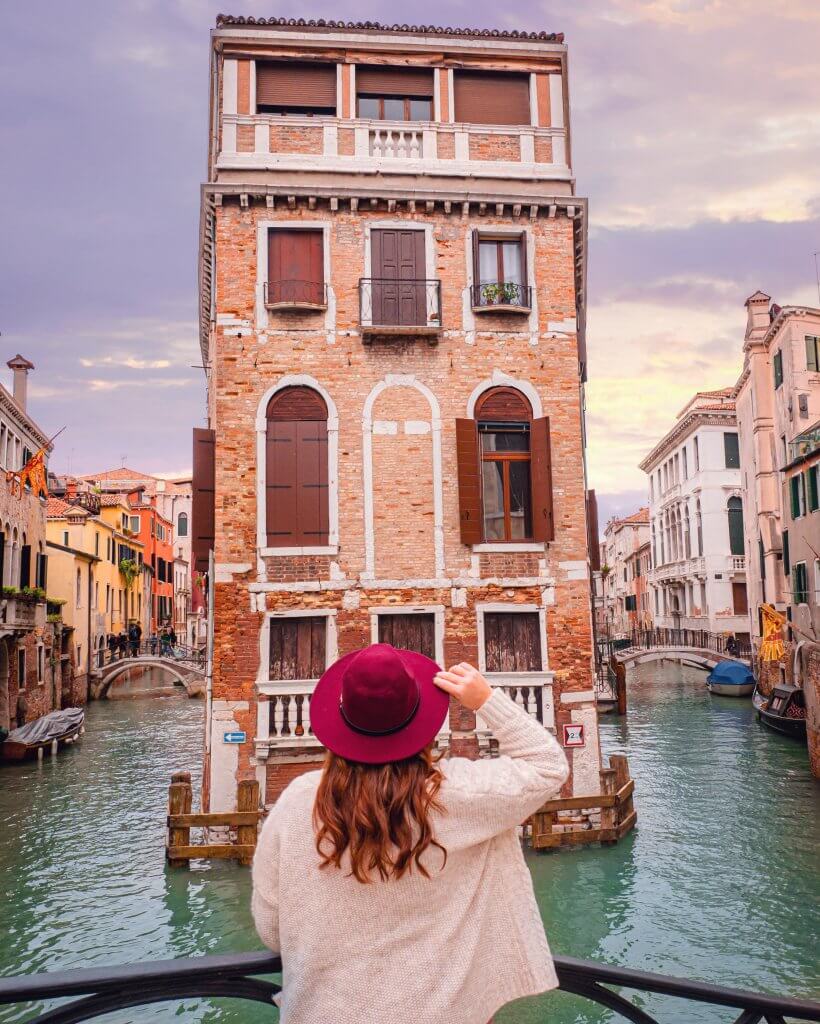 Woman in a red hat with her back to the camera looking at Palazzo Tetta in Castello Venice, the perfect Instagram spot in Venice