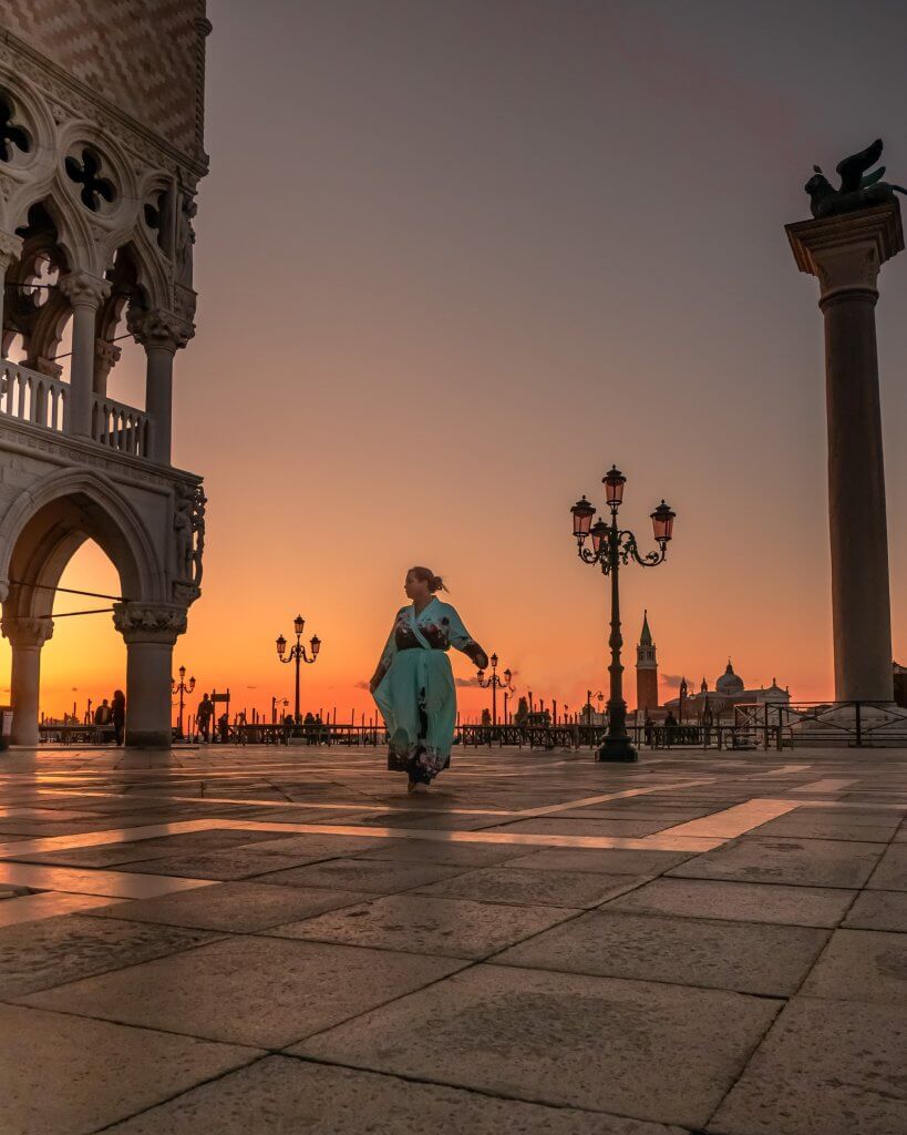 Silhouette of a woman walking at St Mark's Square in Venice one of the best Venice Instagram spots.