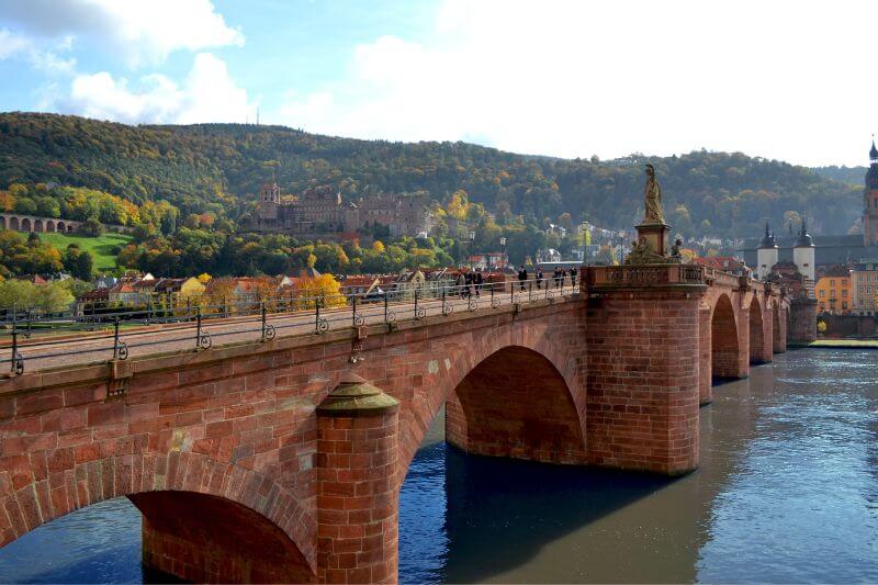 The iconic Karl Theodor Bridge, a symbol of Heidelberg, spanning the Neckar River.
