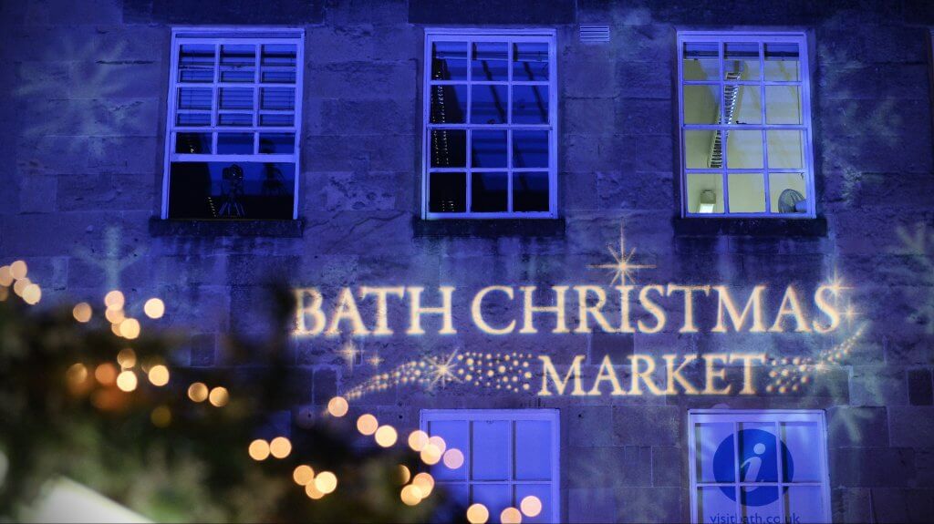 Image of a building in Bath UK with Bath Christmas market projected on to it during a Cotswolds Christmas