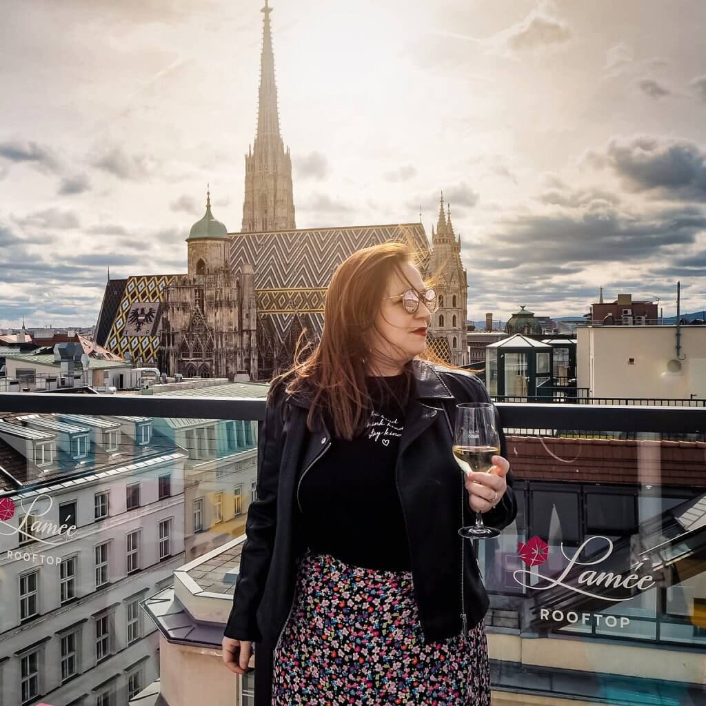 Woman drinking a glass of wine at Lamee rooftop bar in Vienna
