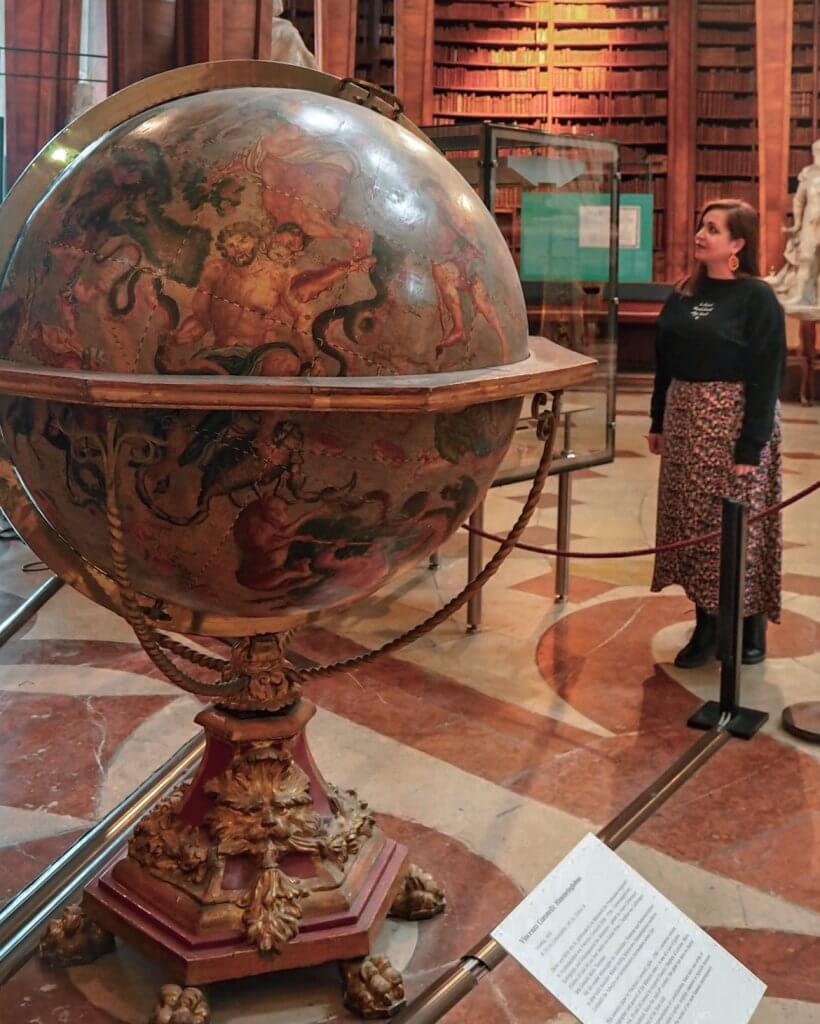 Woman looking at a globe in Austria National Library in Vienna