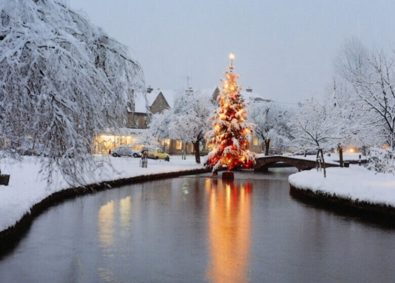 Christmas tree in the water at Bourton on the water in the Cotswolds at Christmas