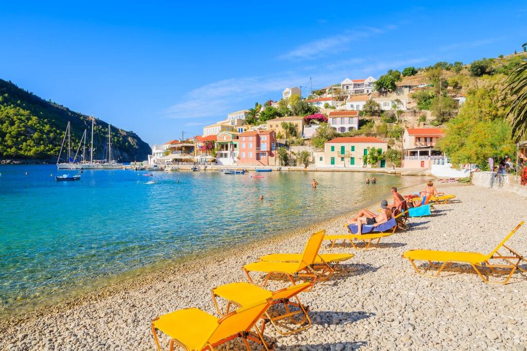 Pebble beach with sunloungers, Assos Beach