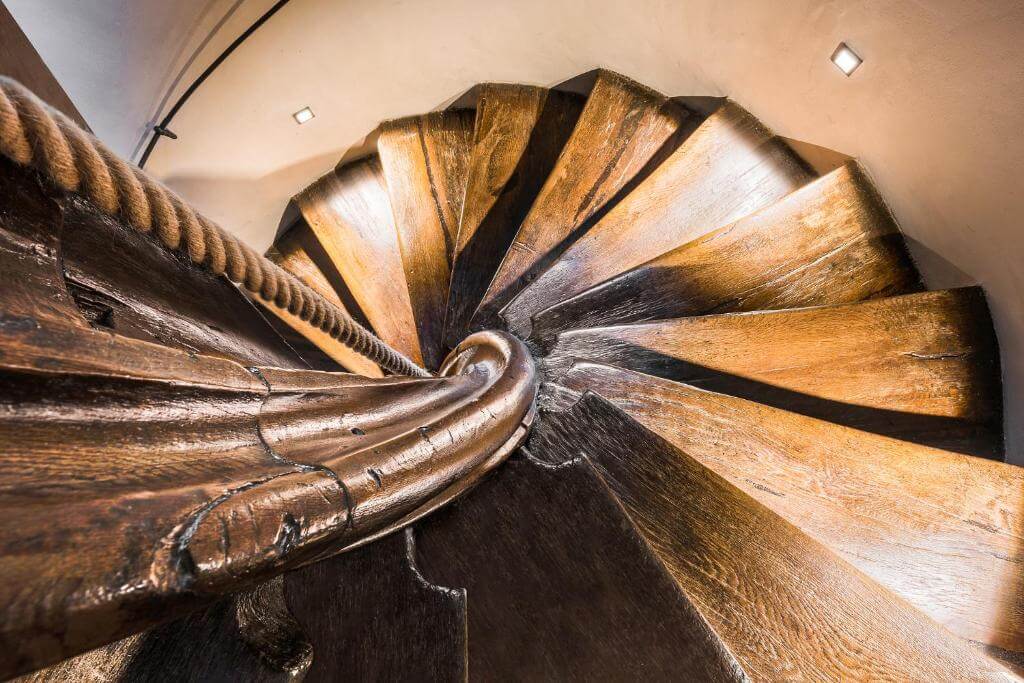Original wooden staircase in Kelley Tower at MOOo by the castle apartments in Prague