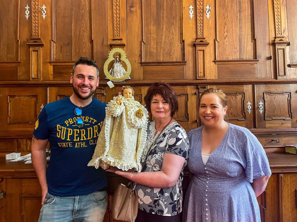 Family holding the infant child of Prague in the sacristy of the church of our lady of victories in Prague Czech Republic