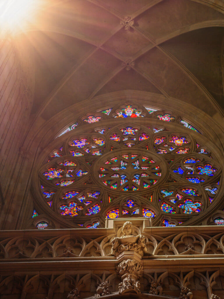 Sun shining through a stained glass window in St Vitus Cathedral Prague