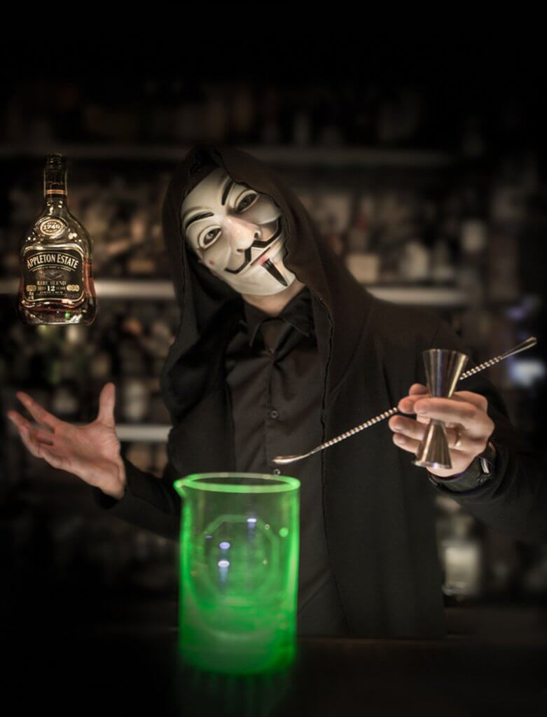 Cocktail barman wearing a Guy Fawkes mask at Anonymous bar Prague