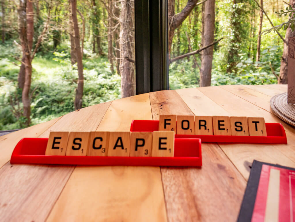 Scrabble tiles spelling forest escape