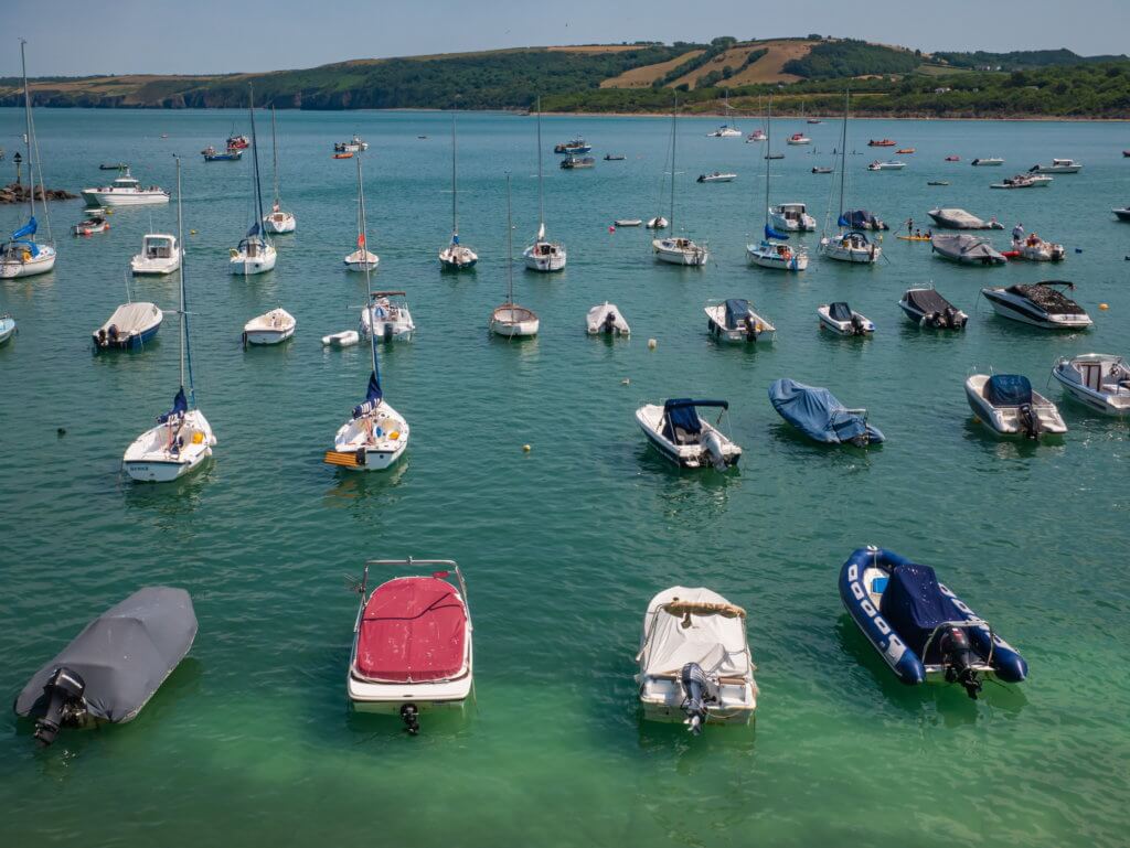 Boats in the water at a beach in New Quay West Wales a must see place on a Wales Roadtrip