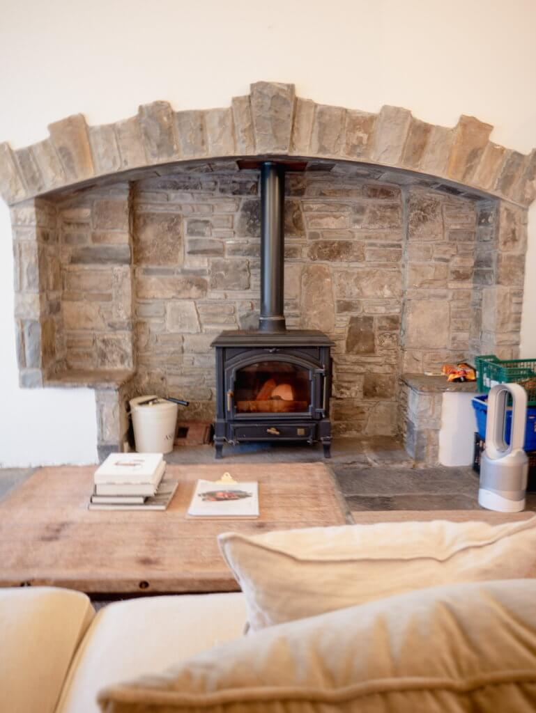 Rustic stone fireplace in Russells Cottage in Doolin Ireland