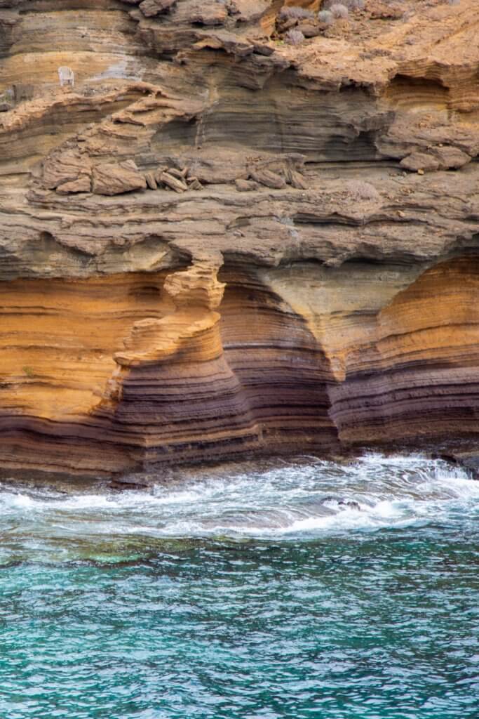 colourful geological formations in the rocks at Playa Amarilla in Tenerife Spain