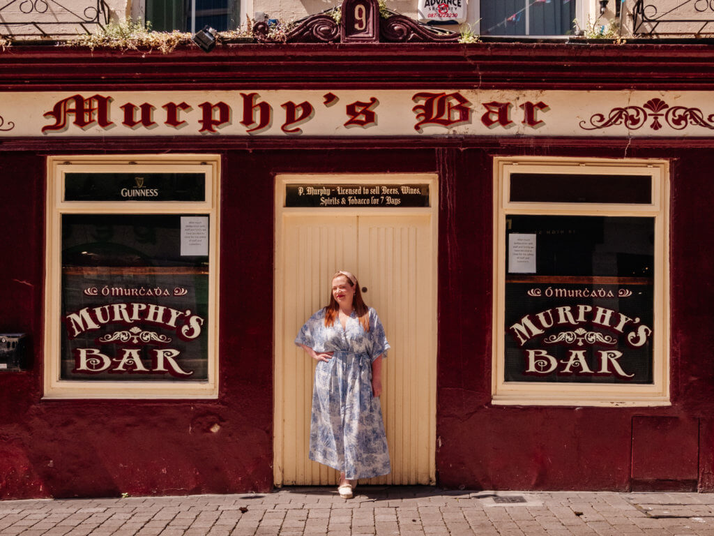Woman in a blue dress posing for a photograph outside Murphy's Bar one of the best Galway City pubs