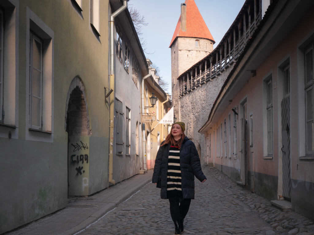 Woman walking along the medieval streets of Tallinn in winter