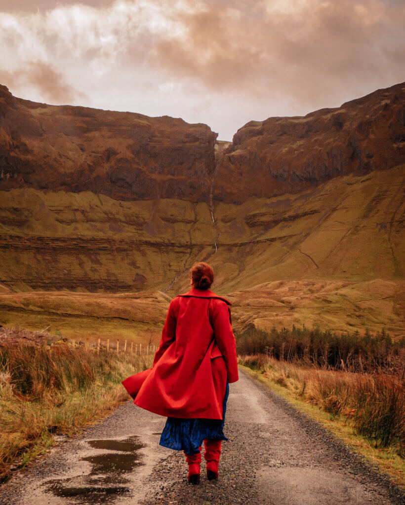 Woman in a red coat walking at Gleniff Horseshoe in Sligo Ireland