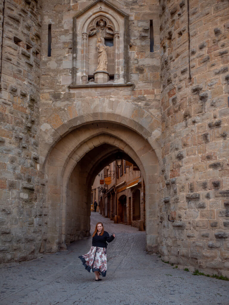 Woman at the entrance to the medieval town of Carcassonne