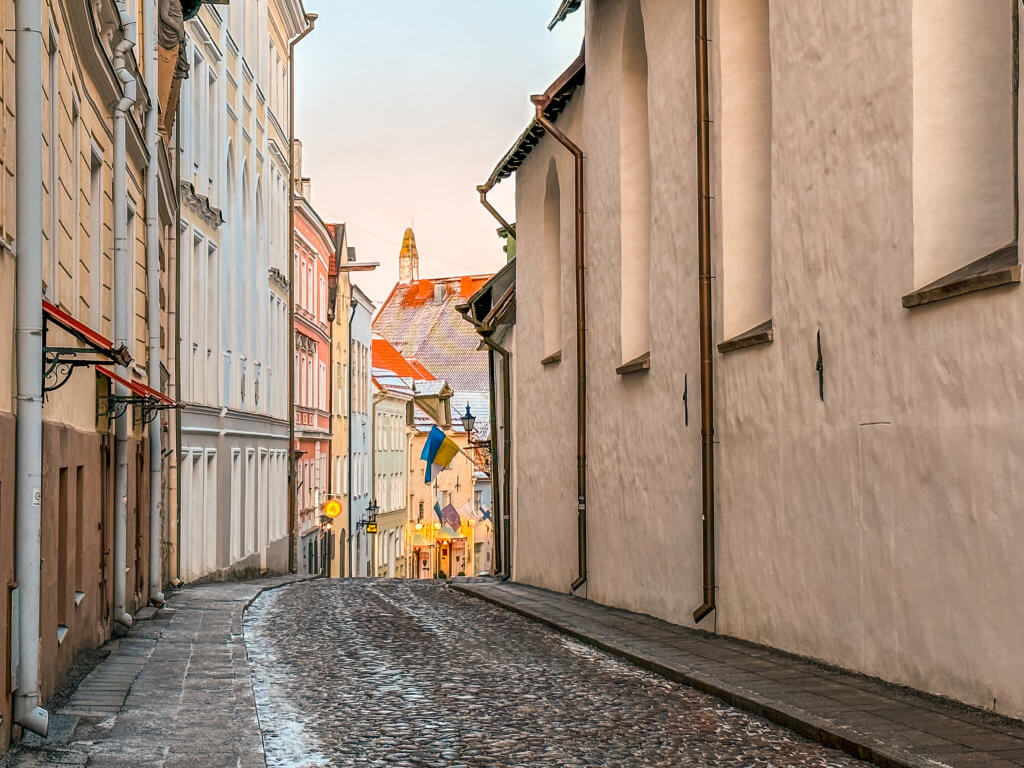 Pastel buildings in Tallinn and cobbled streets covered in snow during winter