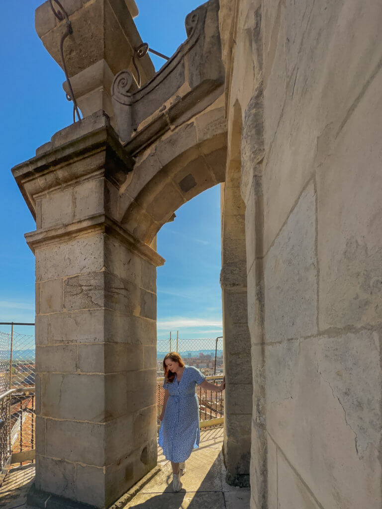 Woman in a blue dress exploring the rooftop of Santa Maria Cathedral a wonderful thing to do in Vitoria Gasteiz Spain