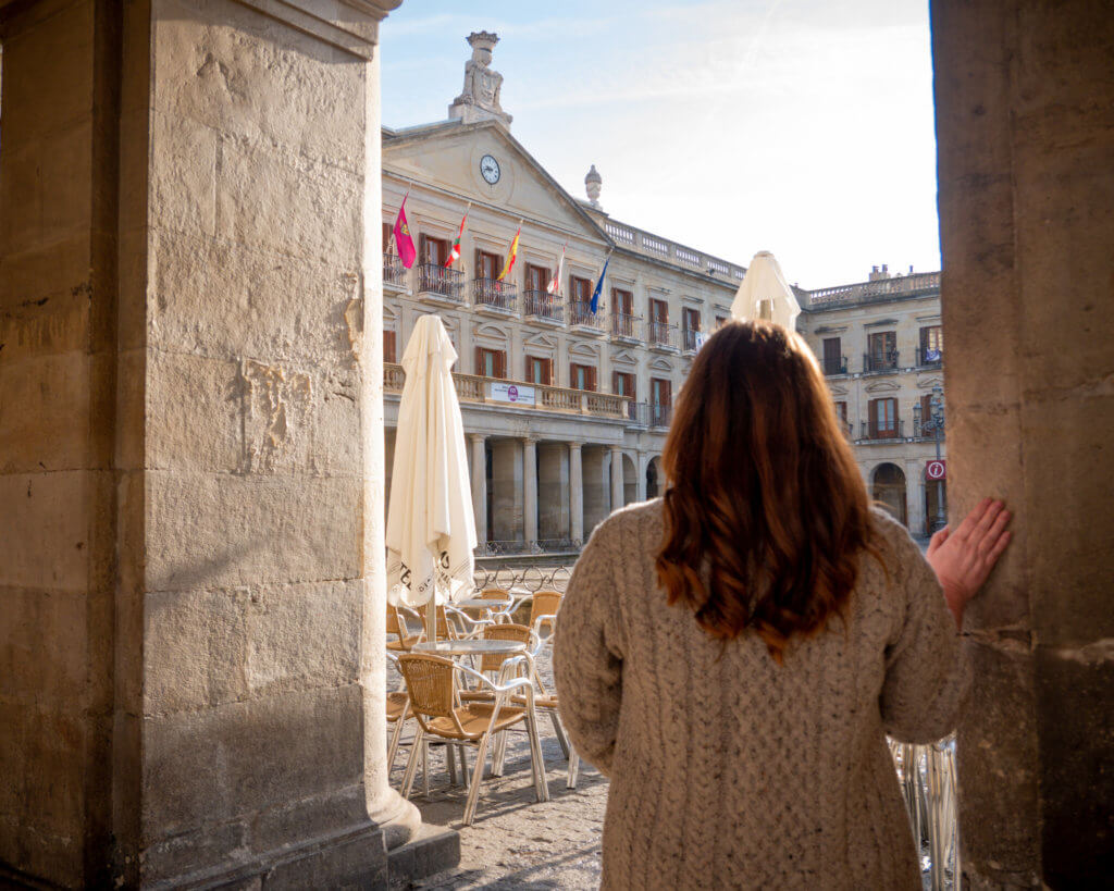 Woman looking at the town hall in Vitoria Gasteiz