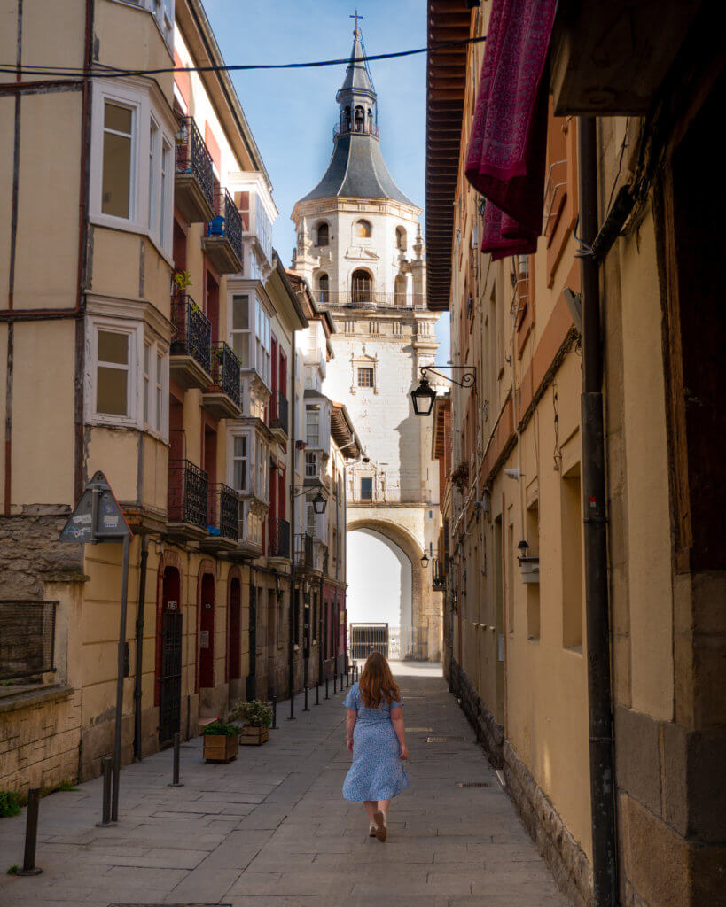 woman walking down the medieval streets of Vitoria Gasteiz in Basque Country Spain