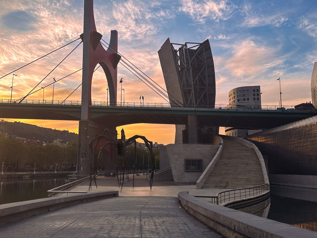 Maman sculpture and Guggenheim museum in Bilbao at sunrise