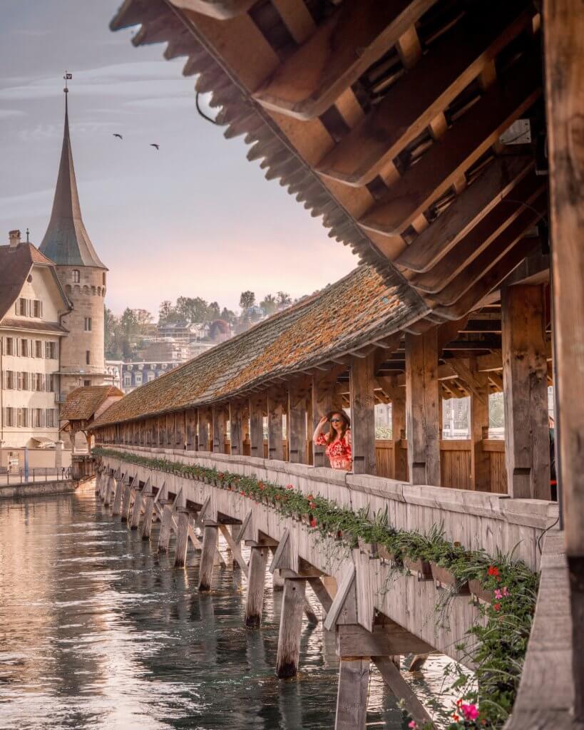 Nicola Lavin Travel Blogger stands on the famous wooden Chapel Bridge in Lucerne Switzerland during 24 hours in Lucerne.