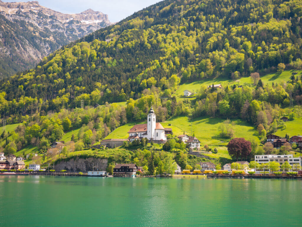 Charming village of Fluelen photgraphed from a boat on Lake Lucerne