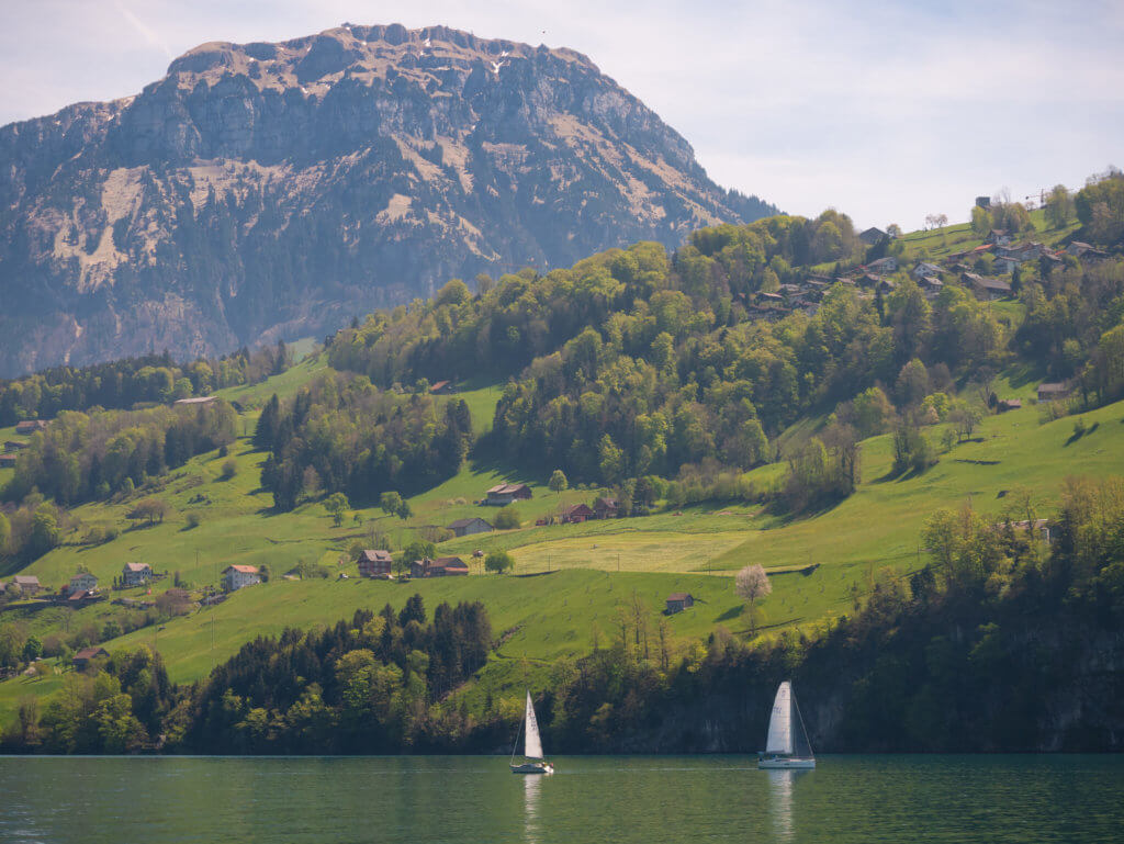 two sailboats surrounded by mountains on Lake Lucerne