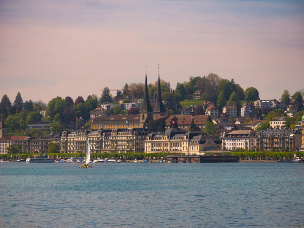 Lucerne city at dusk viewed from a boat on Lucerne Lake