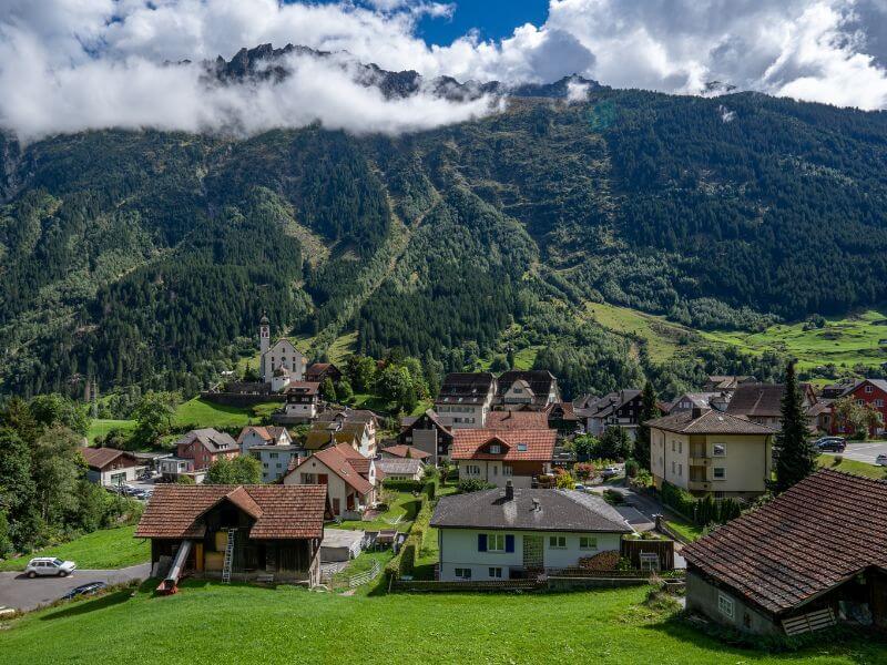 Charming village in Switzerland with Wassen church in the background