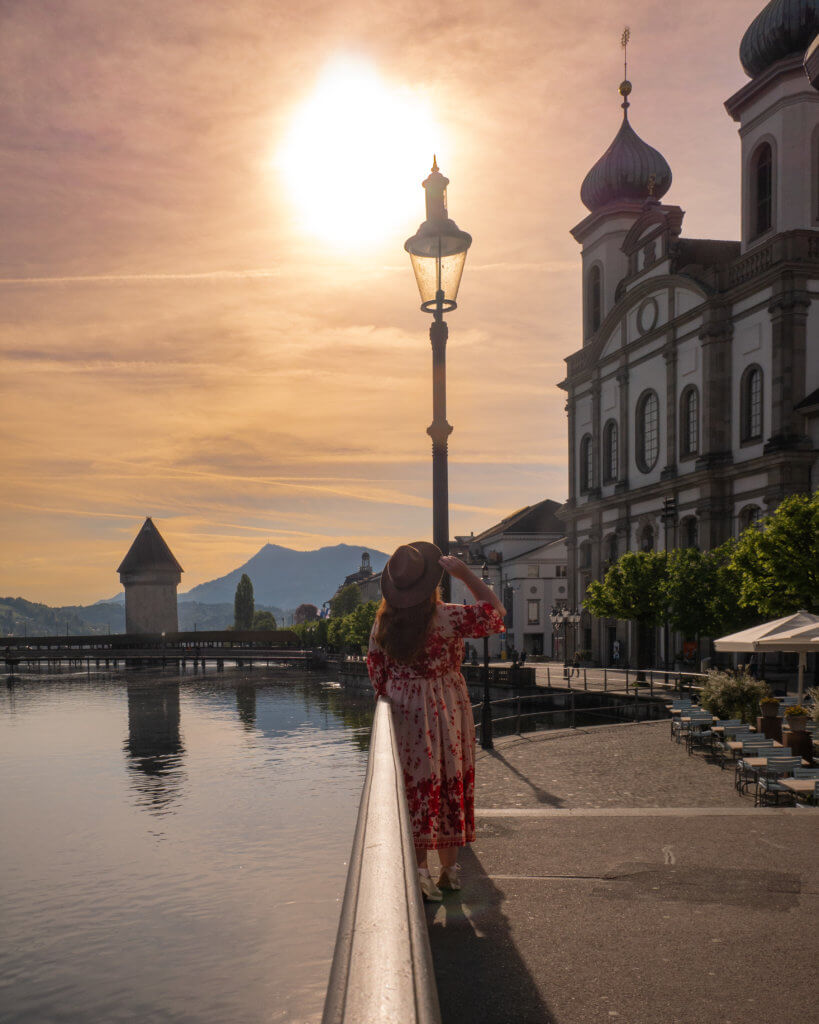 Nicola Lavin Travel Blogger looks at the Jesuit Church in Lucerne at sunrise.