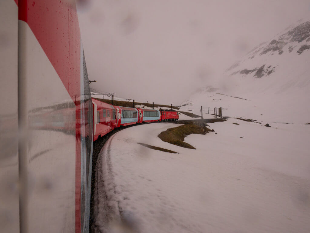 Glacier Express panoramic train travelling through the snowy Alps in Switzerland