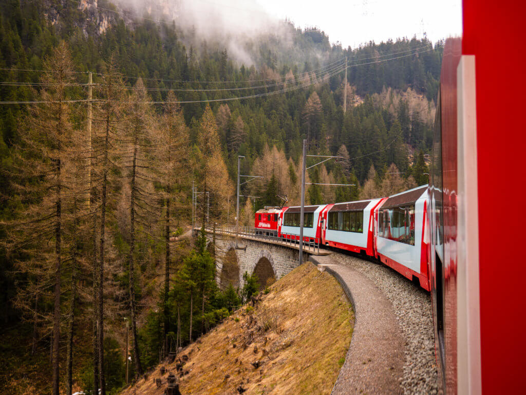 Glacier Express panoramic train travels over Landwasser viaduct in Switzerland