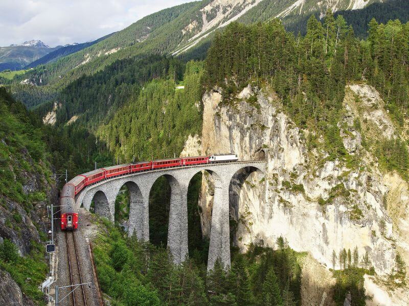 Glacier Express Panoramic Train travelling over the Landwasser Viaduct in Switzerland