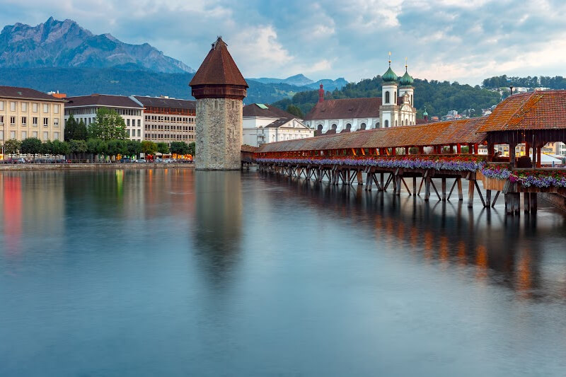Famous wooden Chapel Bridge covered in flowers in Lucerne