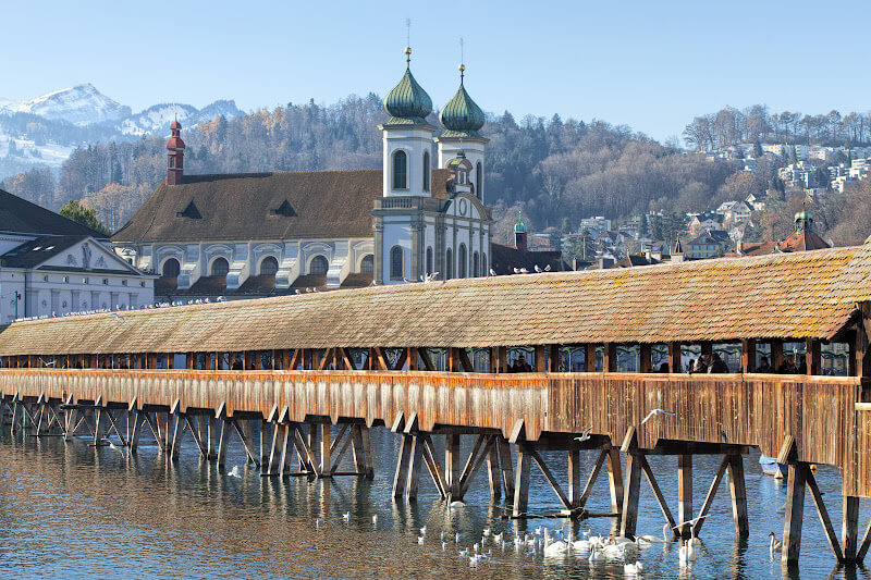 Wooden Chapel Bridge in Lucerne covered with snow  in winter