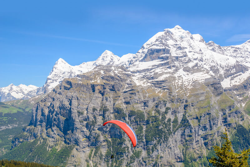 Person paraglides off Mount Pilatus.