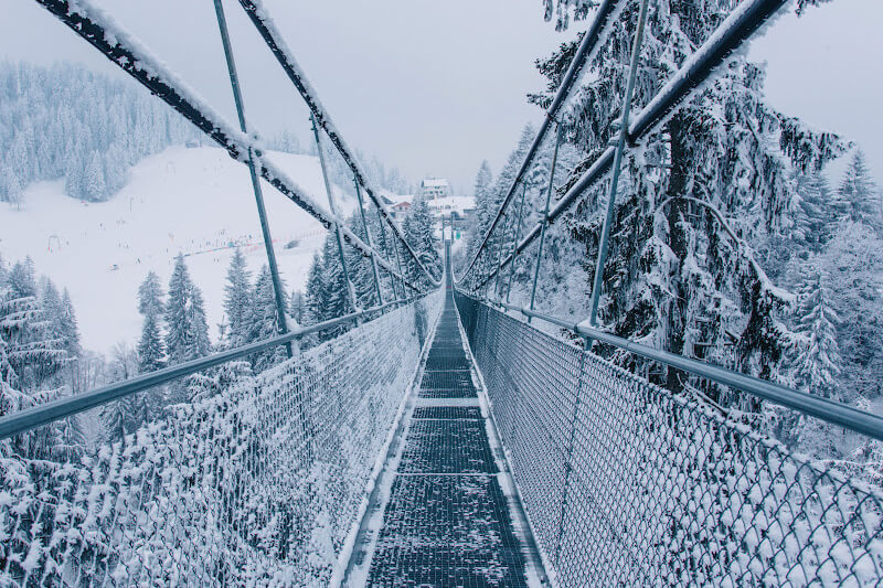 Suspension bridge covered in snow and ice in Lucerne Switzerland