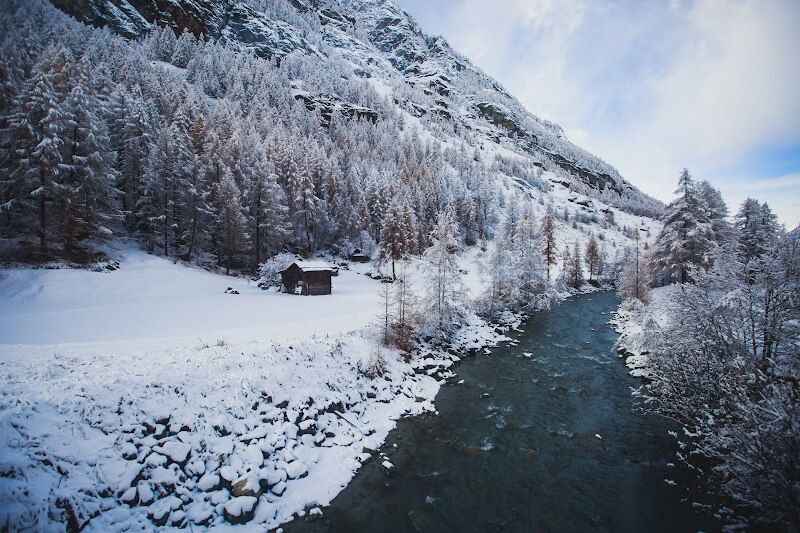 Icy river flowing in a snowy landscape in Lucerne Switzerland during winter