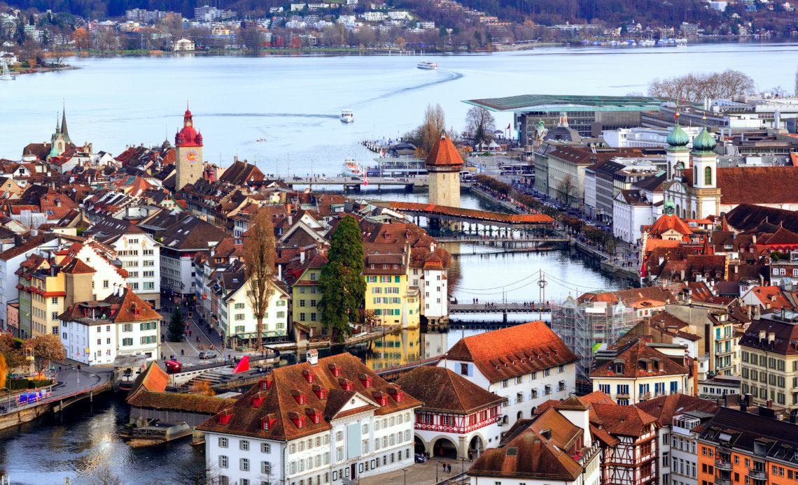 Aerial view of red tile roofs of the old town of Lucerne city covered in snow