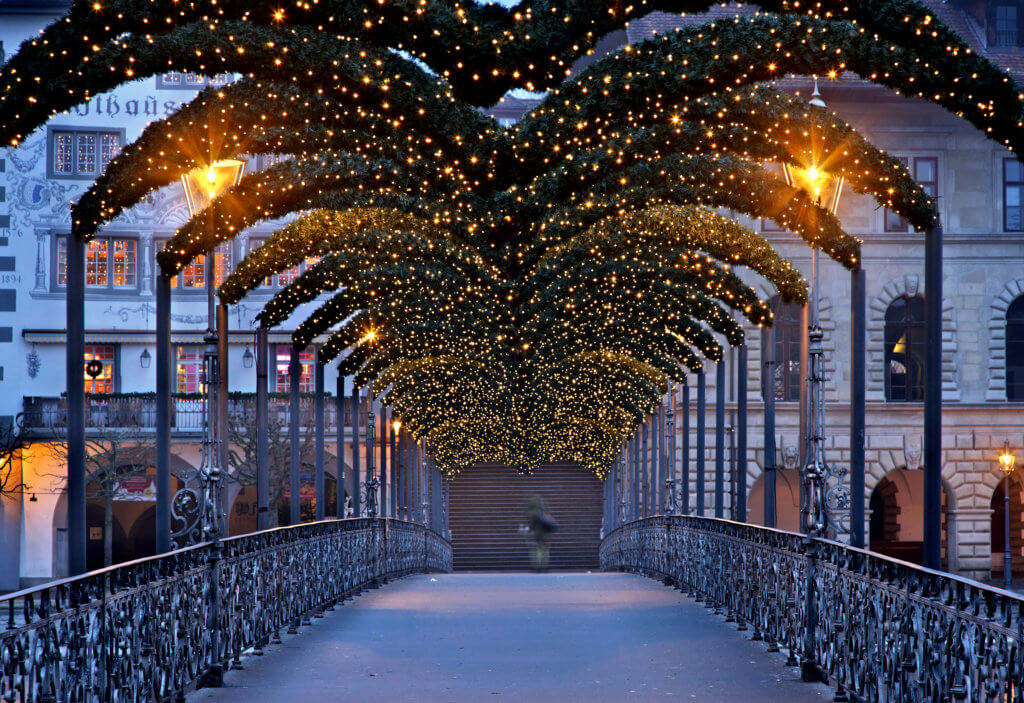 Footbridge over to The Rathaus in Lucerne decorated with Christmas lights