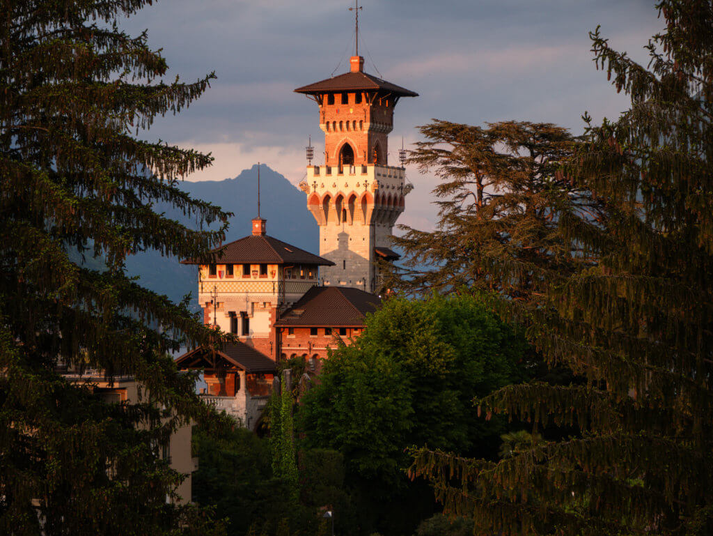 Church spire among trees in Lugano at sunset a must see attraction in Lugano, Switzerland.