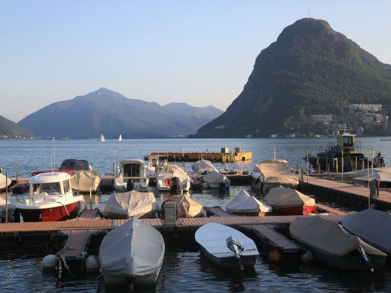 Boats covered in tarp on Lake Lugano in Switzerland