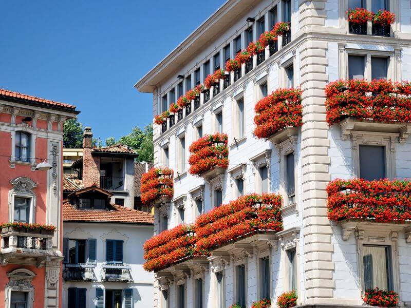 Beautiful building on Via Nassa in Lugano Switzerland with floral window boxes.