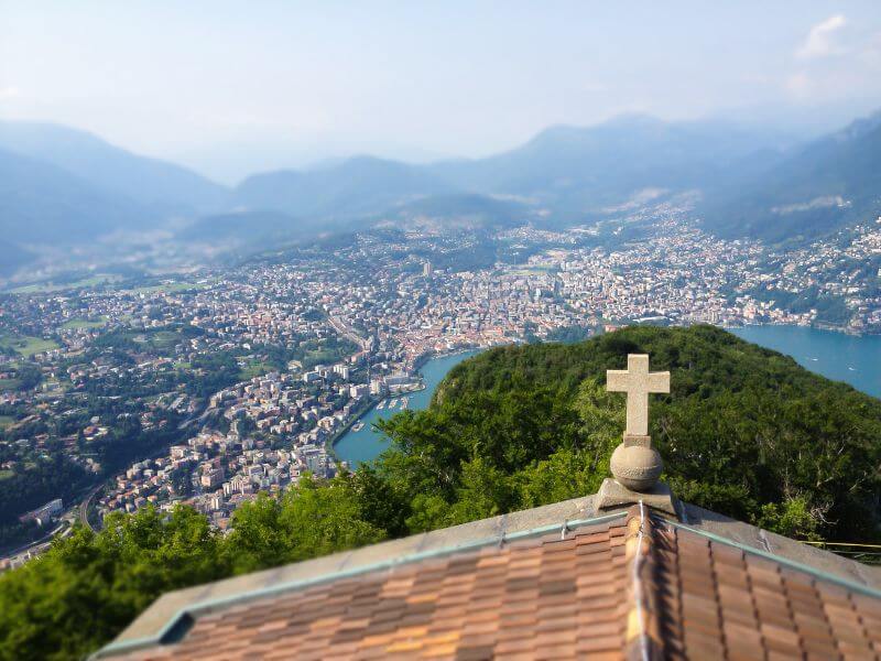 View of Lugano from the roof of a little stone church on the top of Monte San Salvatore in Lugano Switzerland.