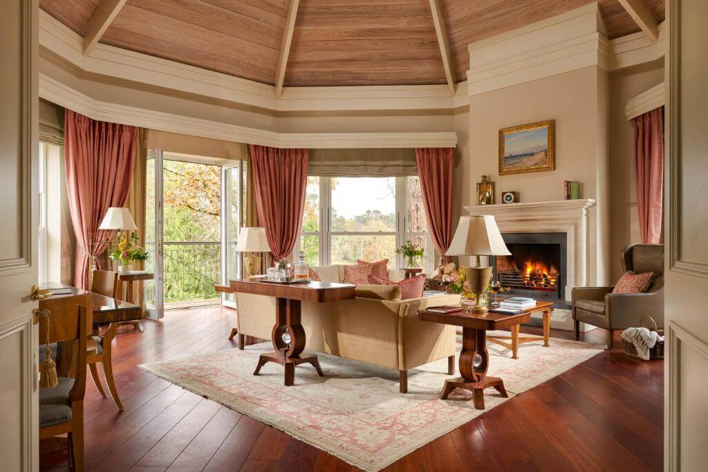Cosy fireplace in a suite at Sheen Falls Lodge, creating a warm and inviting atmosphere for guests to relax.